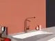 Küchenarmatur von Ideal Standard in Sunset Rose, mit langen Auslauf und modernemDesign, montiert an einem weißen Waschbecken vor einem rosafarbenen Wandhintergrund.